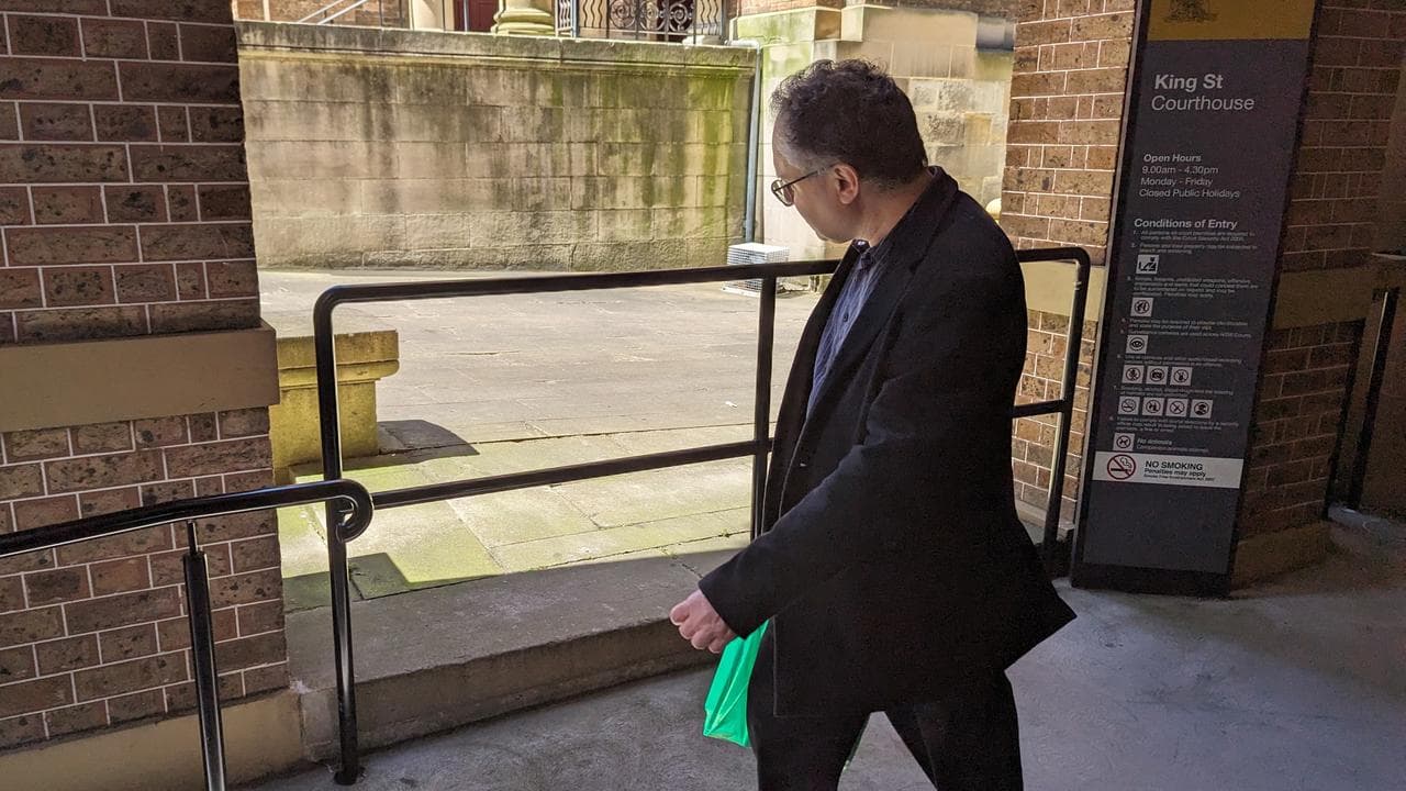 Fraudster Jonatan Kelu departs after a sentence hearing