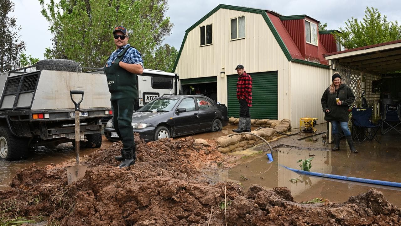 Dan O’Connor standing on a makeshift levee in Tinamba