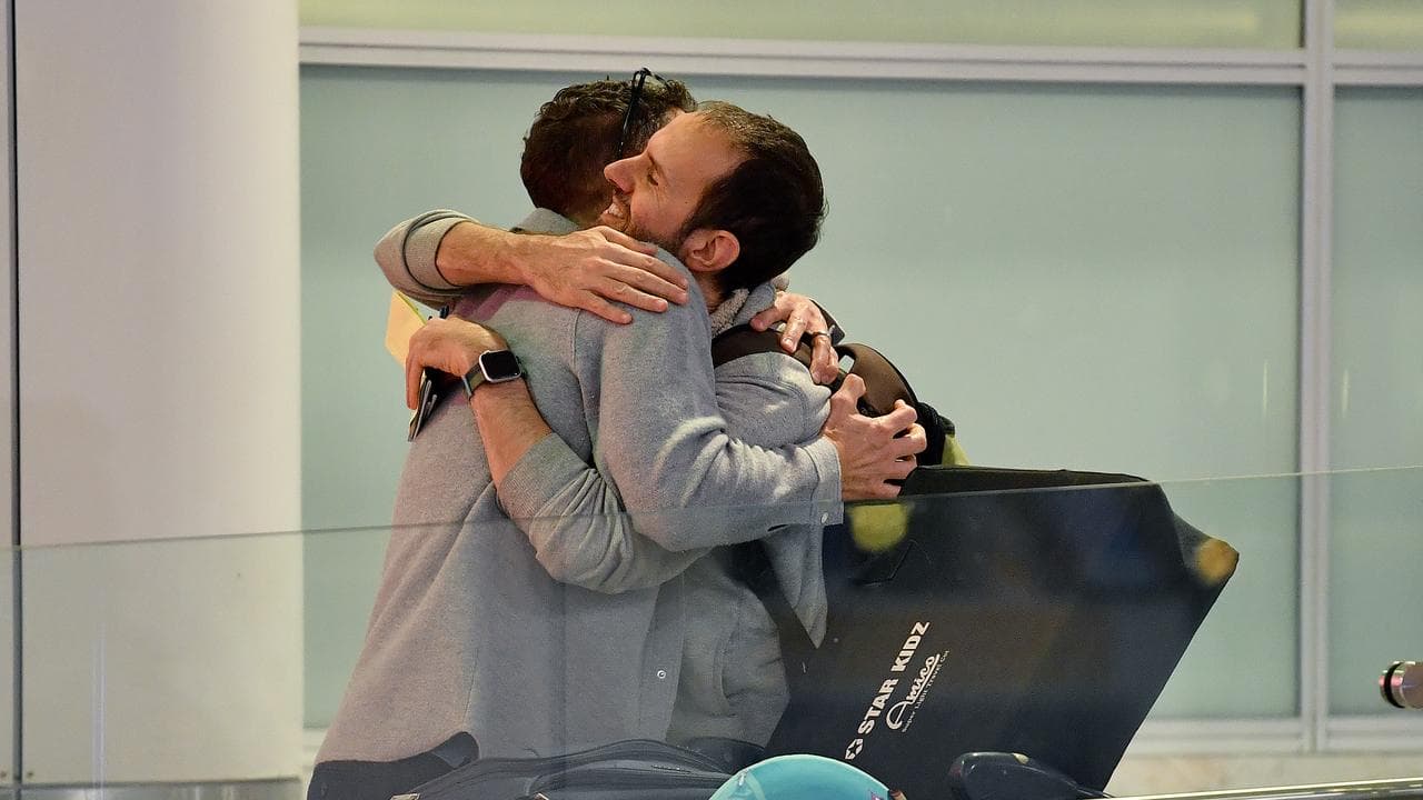 People embrace at Sydney Airport (file image)