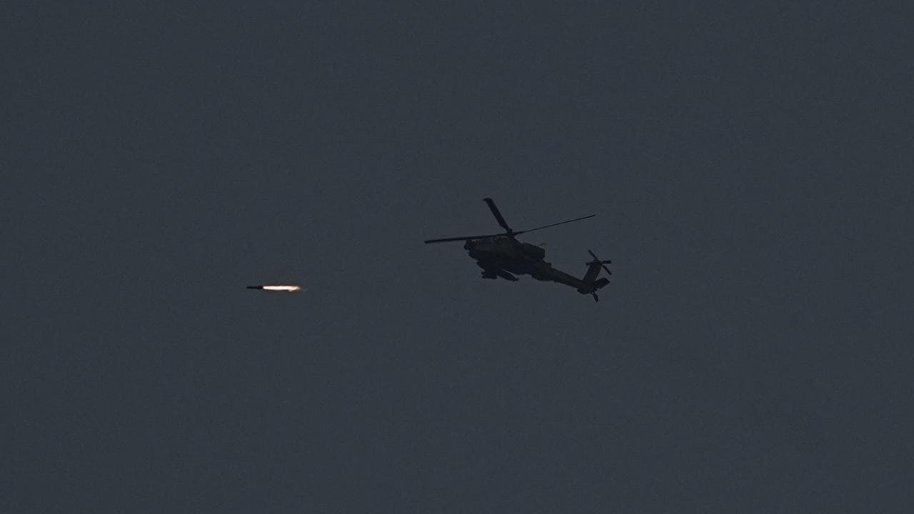 Israeli Apache helicopter fires a missile towards the Gaza Strip
