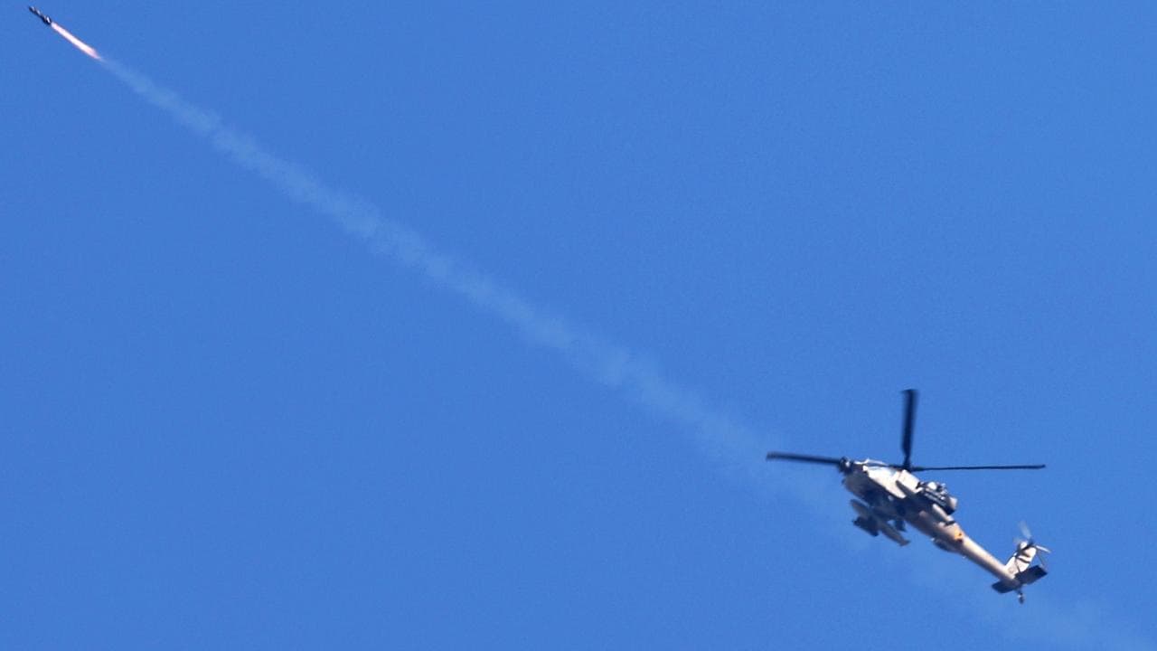 An Israeli Apache helicopter fires a missile over the Gaza Strip