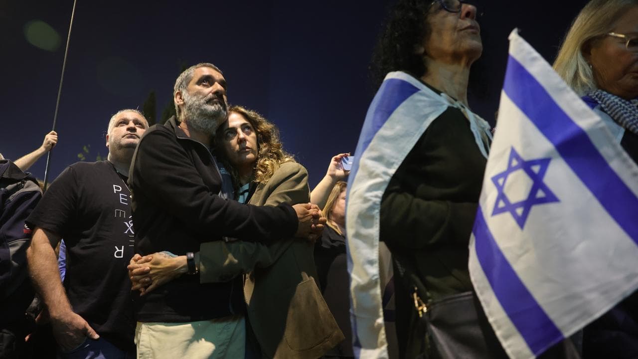 People outside the Knesset commemorate one month since Hamas' attack