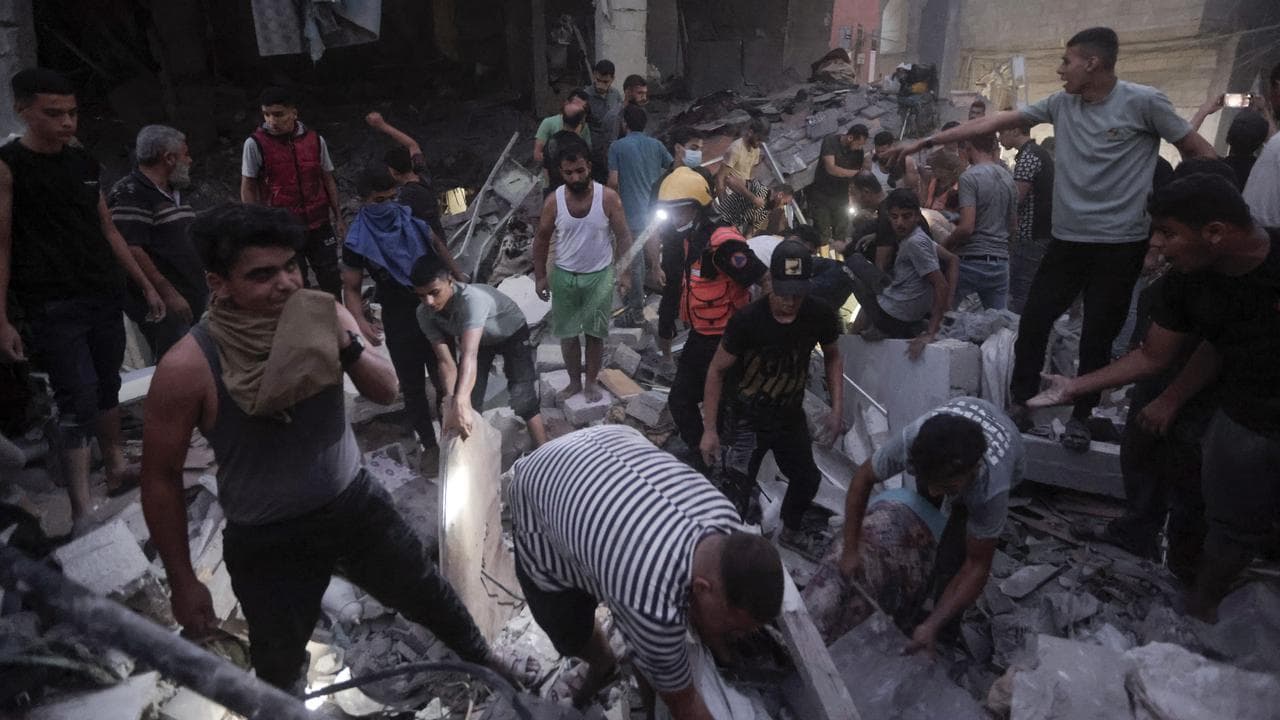 Palestinians look for survivors after an Israeli strike in Khan Younis