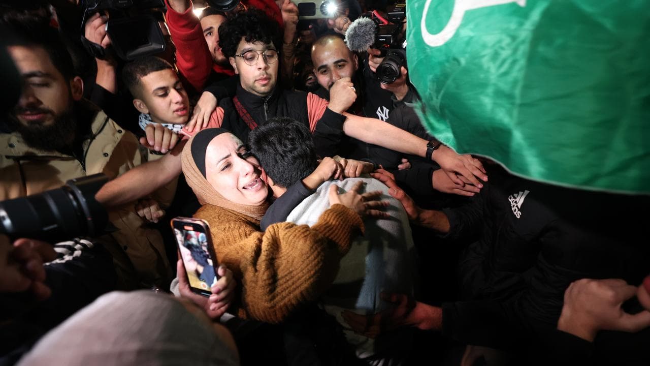 A Palestinian hugs a family member in Ramallah after their release