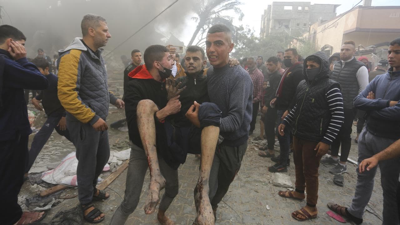 Palestinians evacuate survivors of an Israeli strike in Rafah