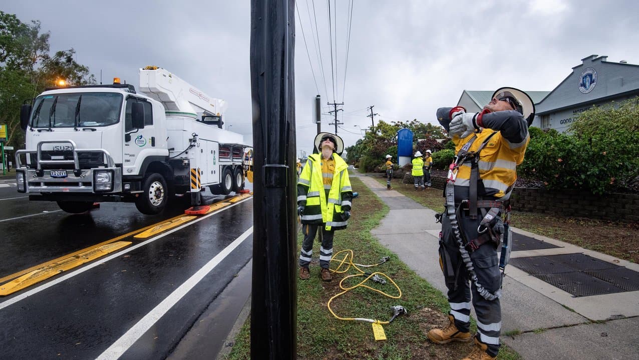 Electricians work to restore power in Cairns after Cyclone Jasper.