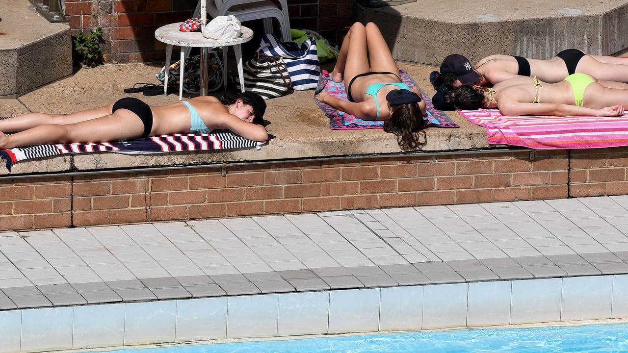 People lying in the sun at North Sydney Olympic Pool