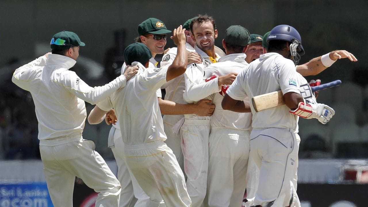 Nathan Lyon is mobbed after dismissing Kumar Sangakkara, in 2011.