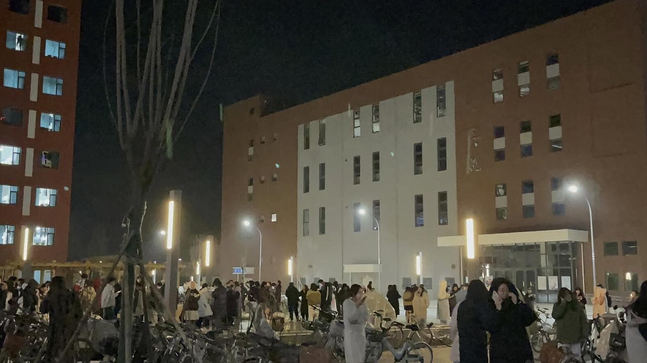 Students gather after dormitories were evacuated at Lanzhou University