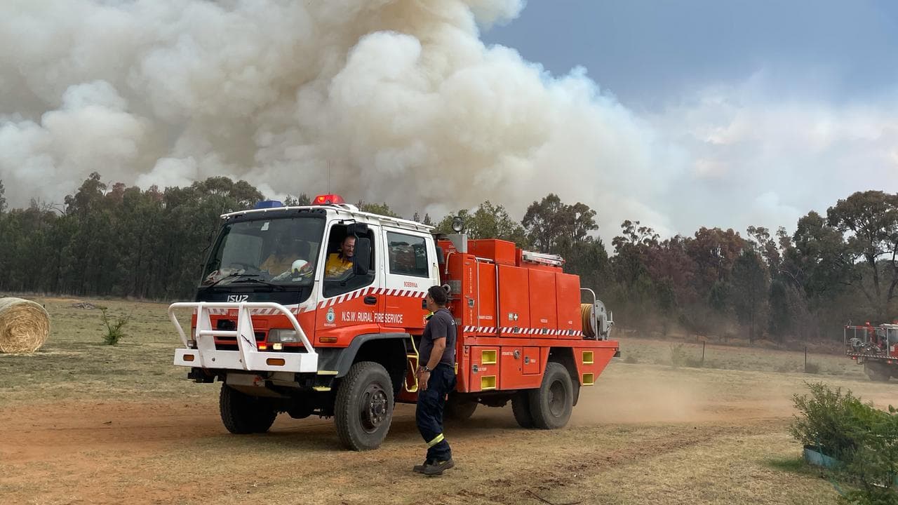 Firefighters and truck south of Narrabri in front of a fire.