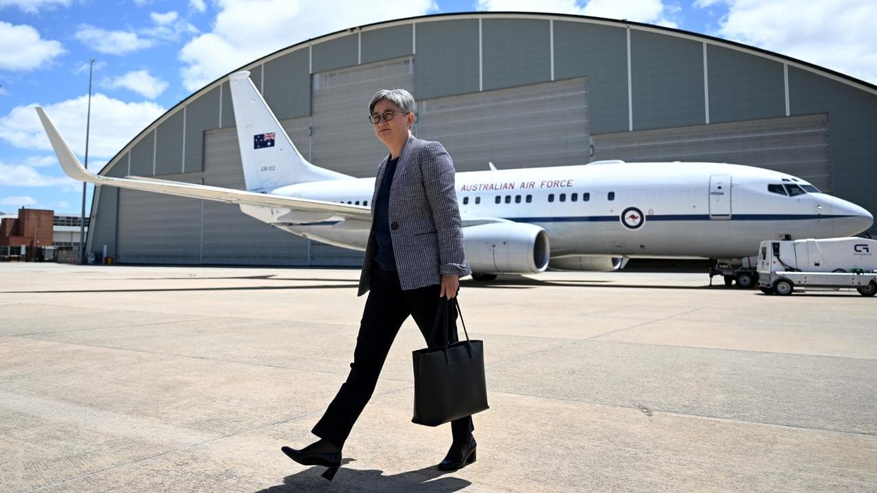 Foreign Minister Penny Wong prepares to board a plane in Canberra.