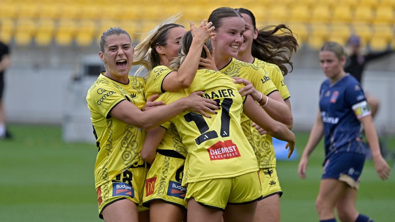 Wellington players celebrate a Mariana Speckmaier goal.