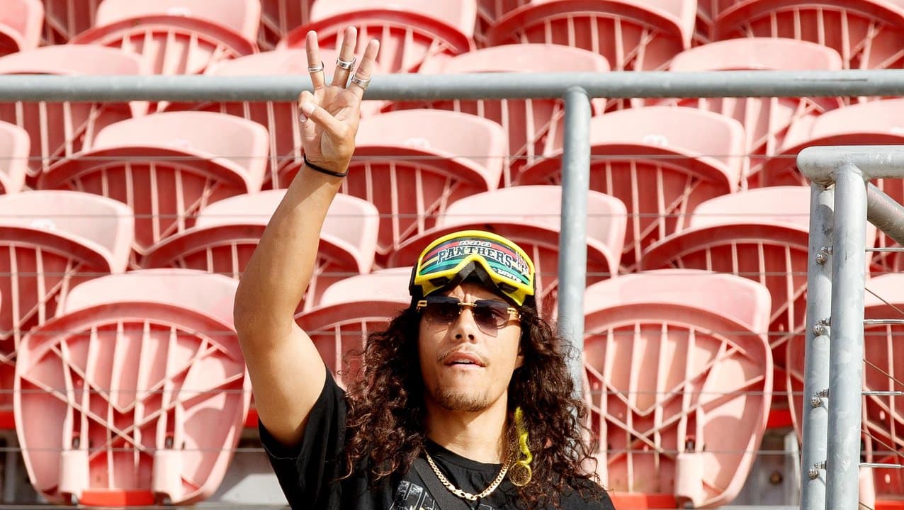 Jarome Luai holds up three fingers signifying his consecutive titles.