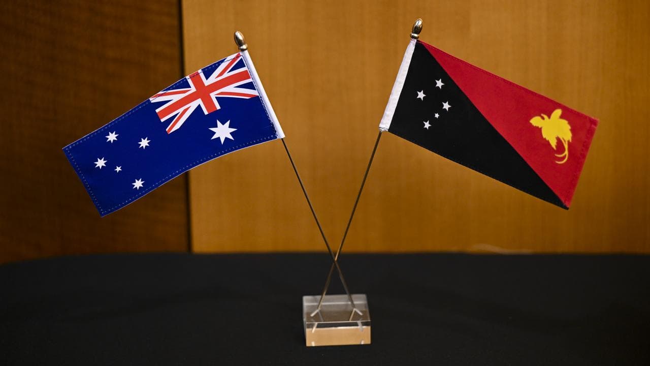 An Australian flag and the flag of Papua New Guinea