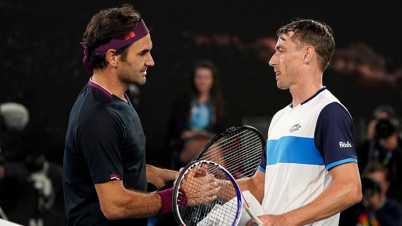 Roger Federer (left) and John Millman at the 2020 Australian Open.
