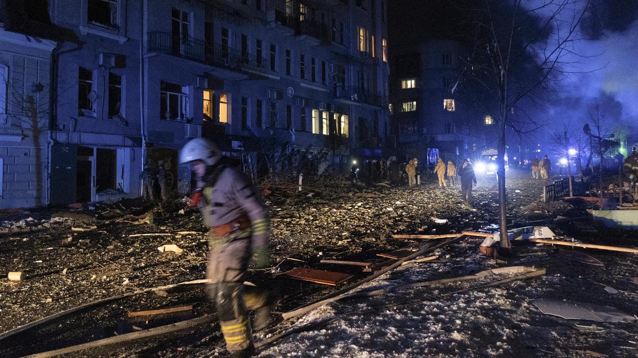 Ukrainian rescuers at the site of a rocket attack in downtown Kharkiv