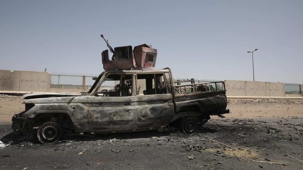 A destroyed military vehicle is seen in southern in Khartoum