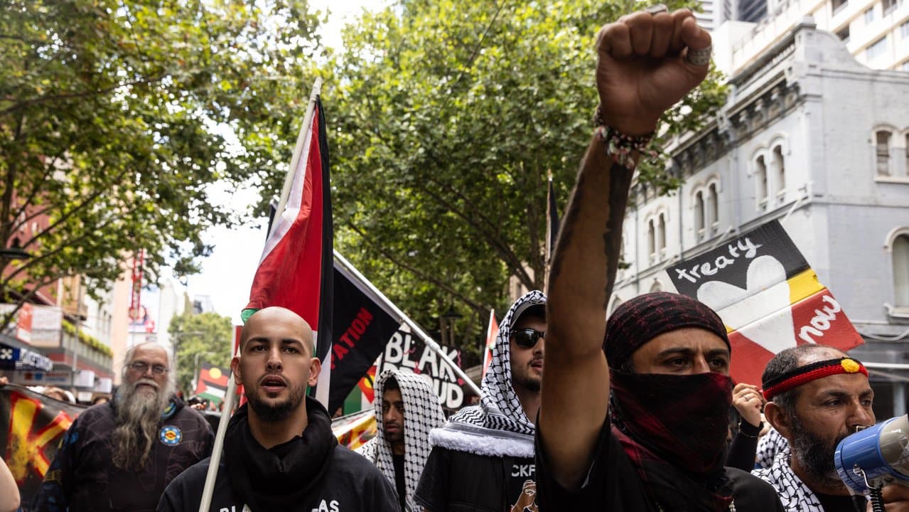 People march towards Flinders Street Station