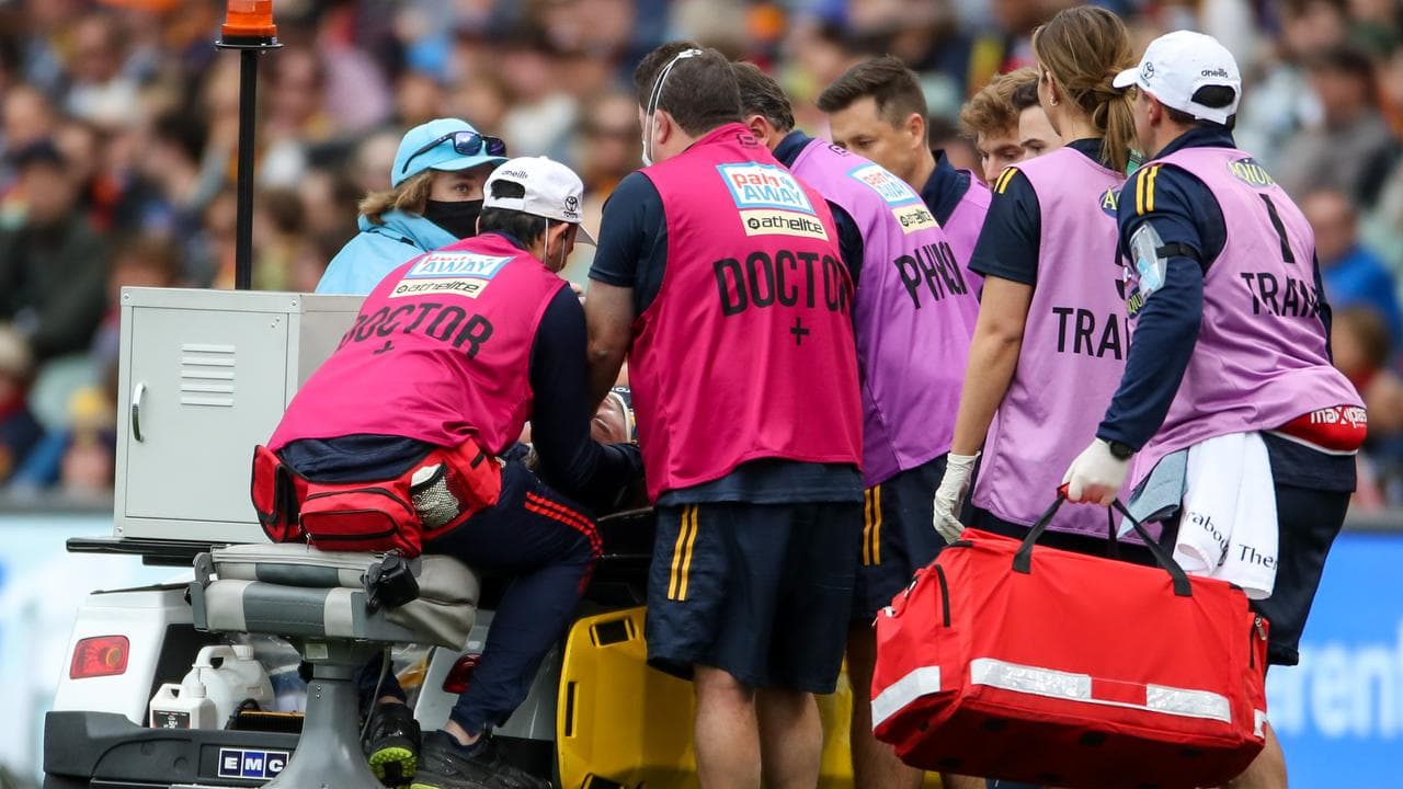 Medics deal with an on-field concussion at the AFL.
