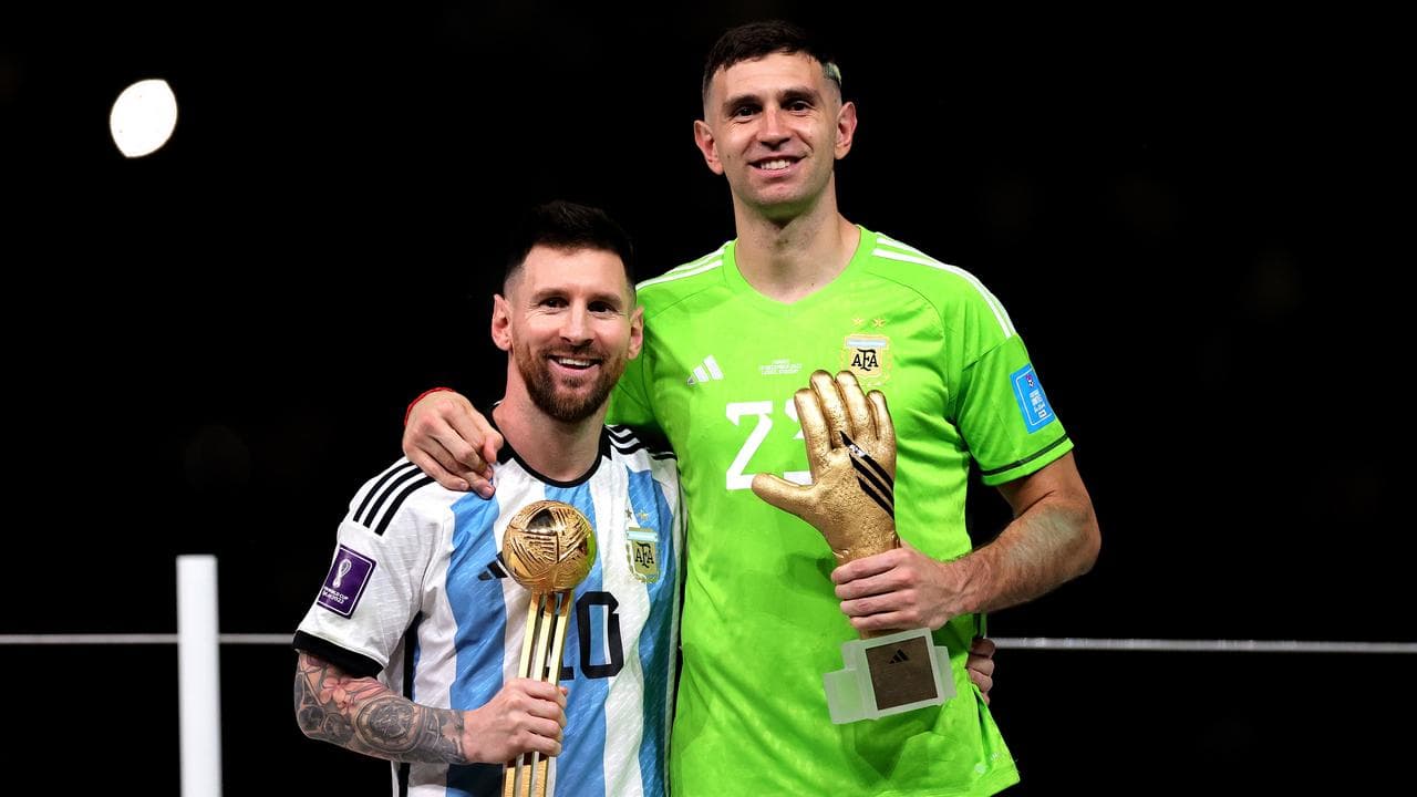 Lionel Messi (left) and Emiliano Martinez.