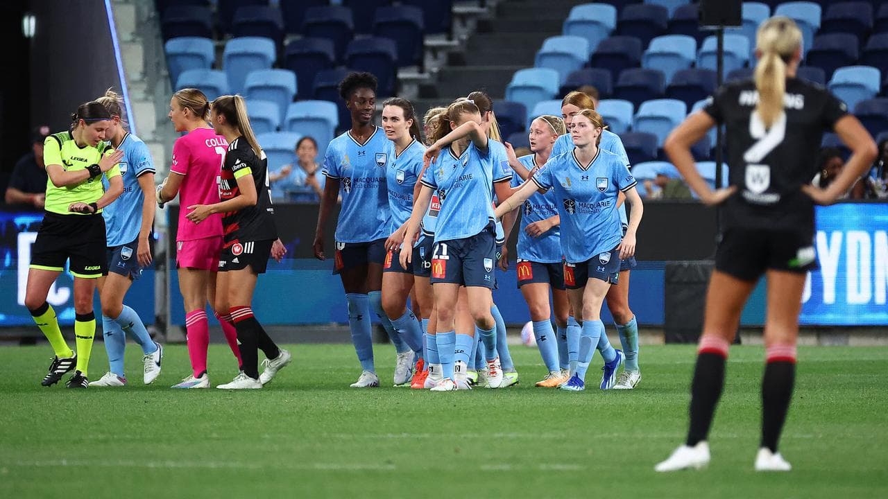 Sydney FC players celebrate a goal.