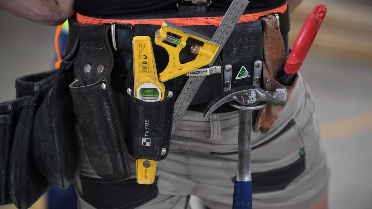 A carpenter wearing a tool belt