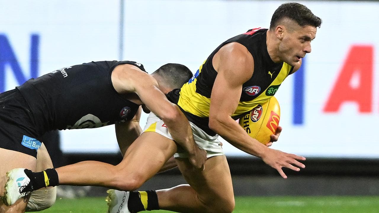 Dion Prestia is tackled by Matthew Kennedy.