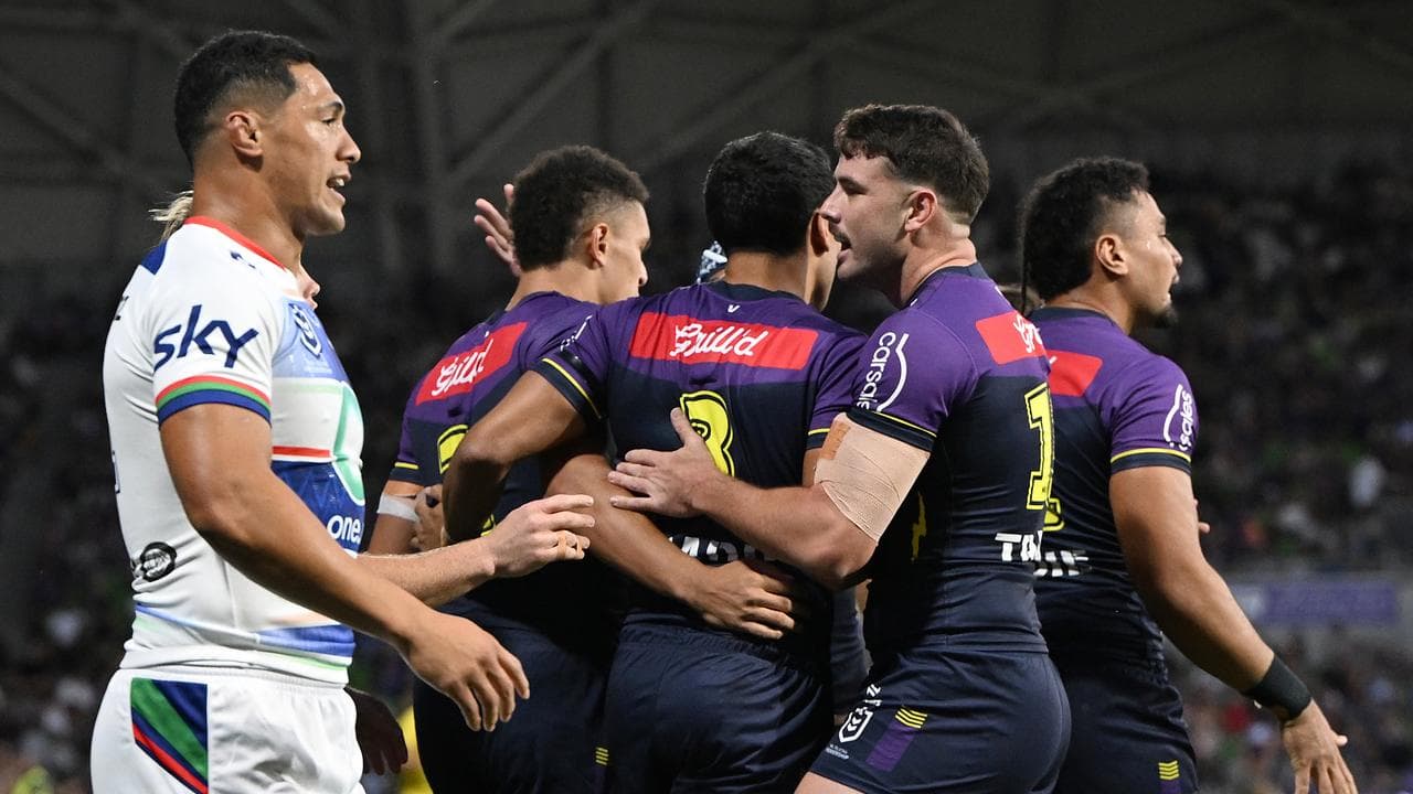 Melbourne Storm players celebrate a try.