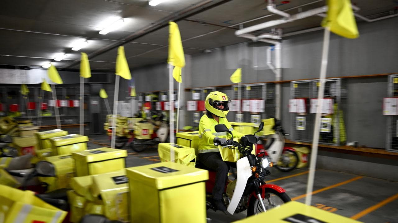 Australia Post delivery workers preparing to deliver mail