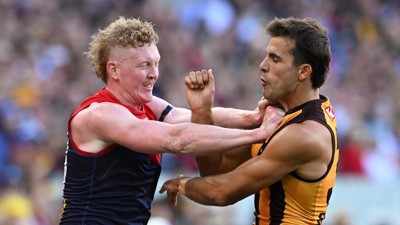 Clayton Oliver (left) and Hawthorn's Finn Maginness.