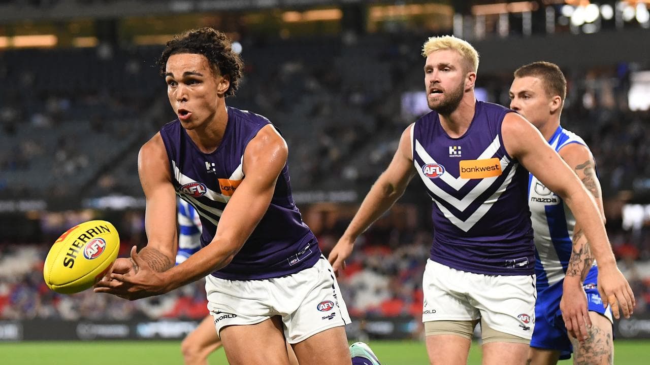 Fremantle's Josh Draper handballs against the Kangaroos. 