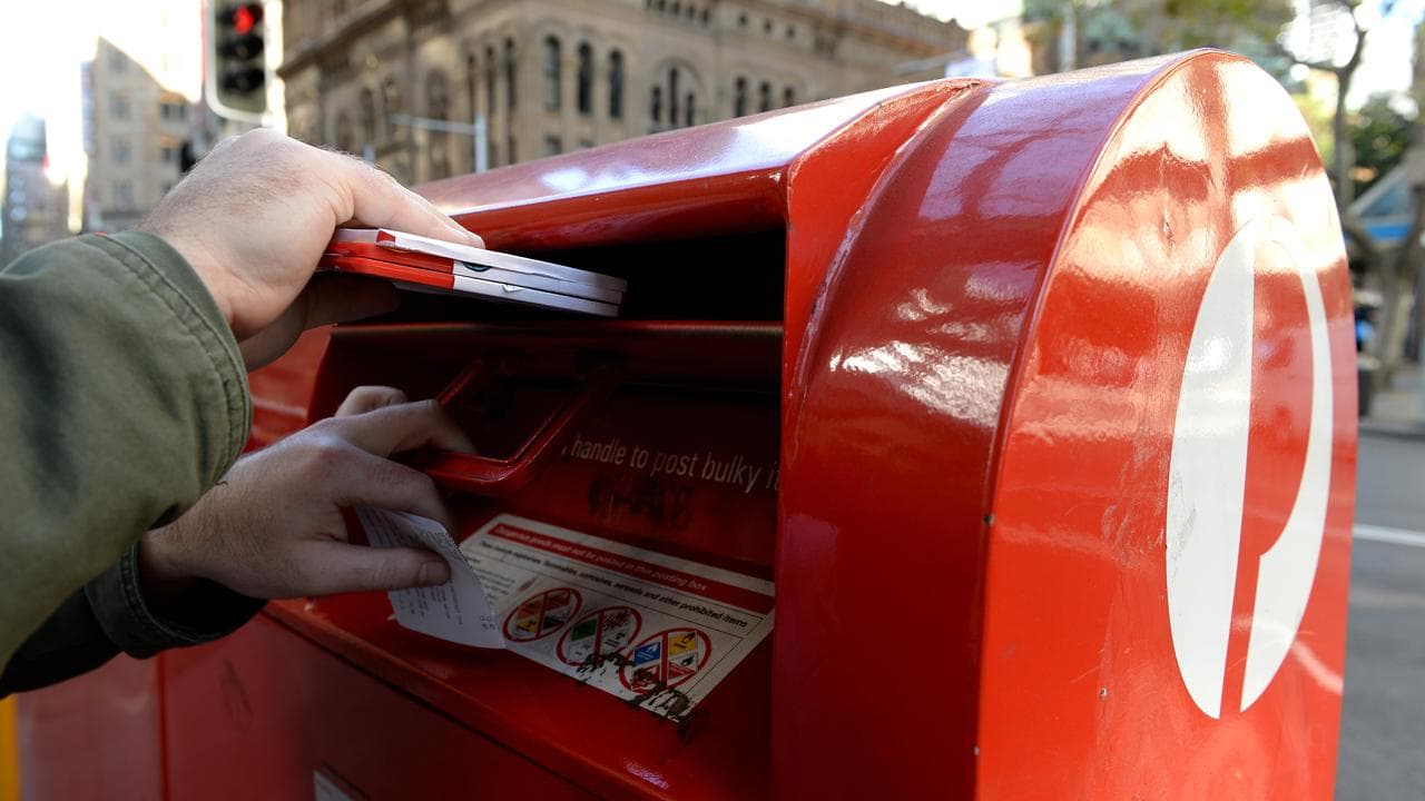 A person posting a letter