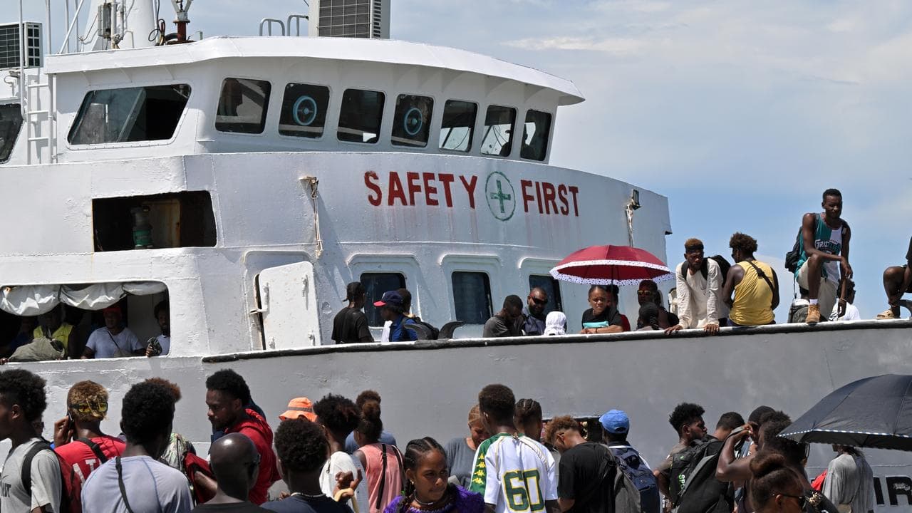 Voters board the already overcrowded Fair Glory ferry in Honiara