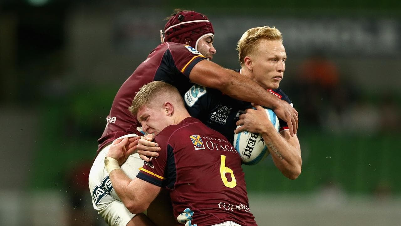 Carter Gordon (right) rides a tackle against the Highlanders. 