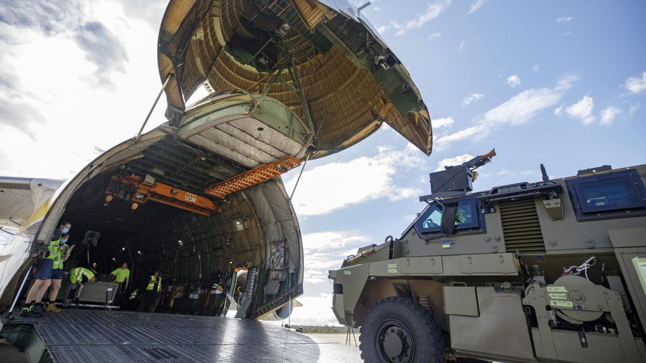 Vehicles being loaded on to a plane