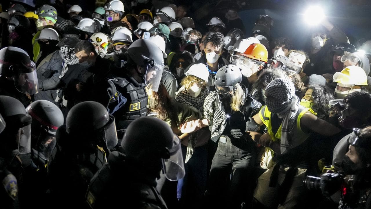Police officers confront demonstrators