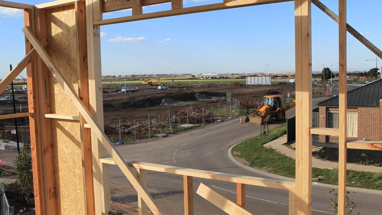 A house being built looking over a cleared paddock.