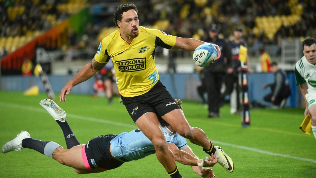 The Hurricanes' Billy Proctor scores a try.