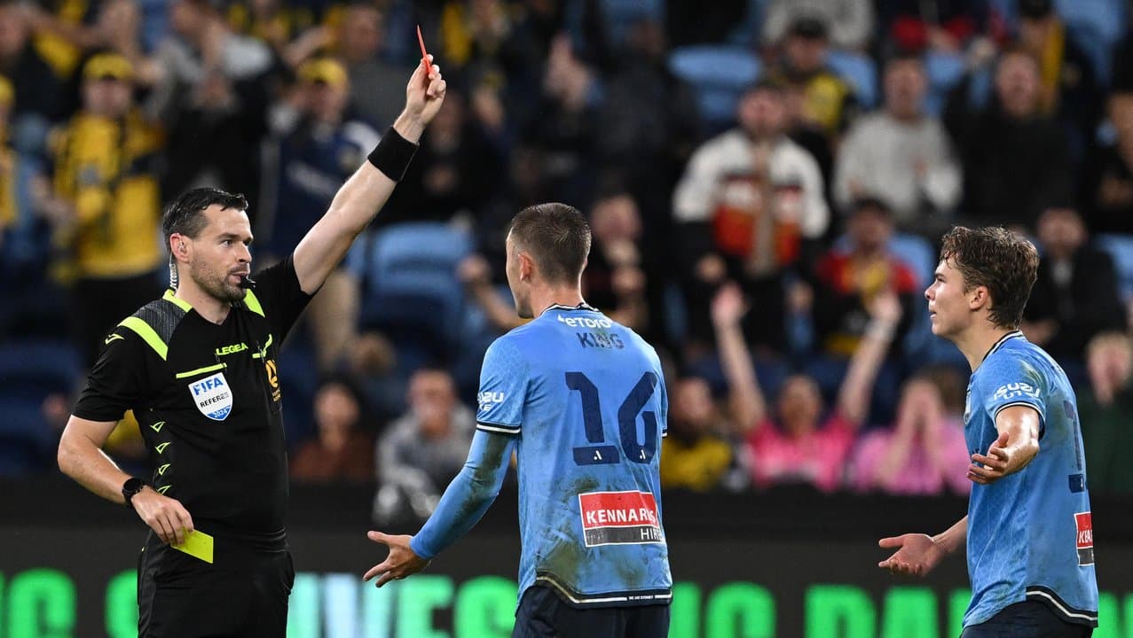 Sydney FC's Corey Hollman (right) is sent off against the Mariners.