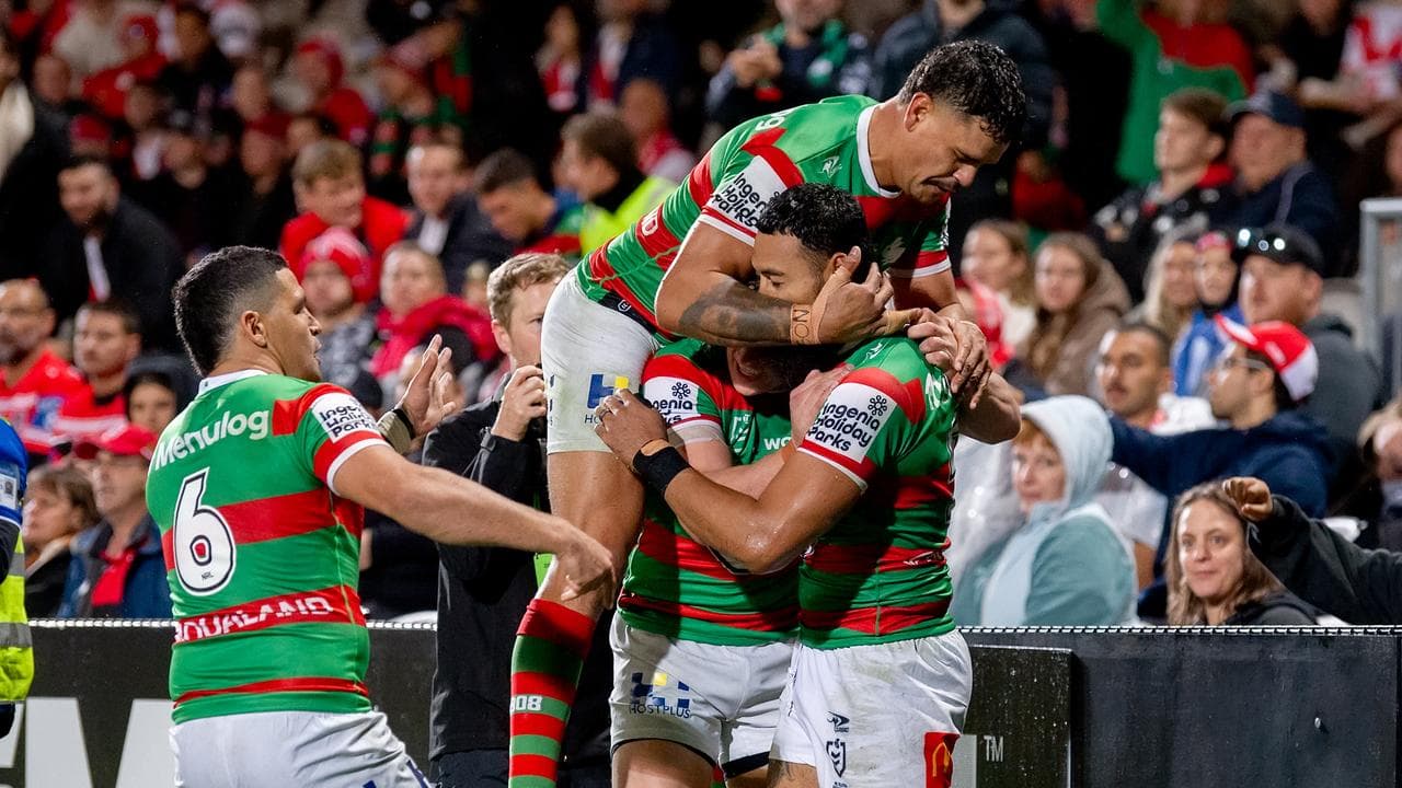 Rabbitohs players celebrate Izaac Thompson's second-half try.