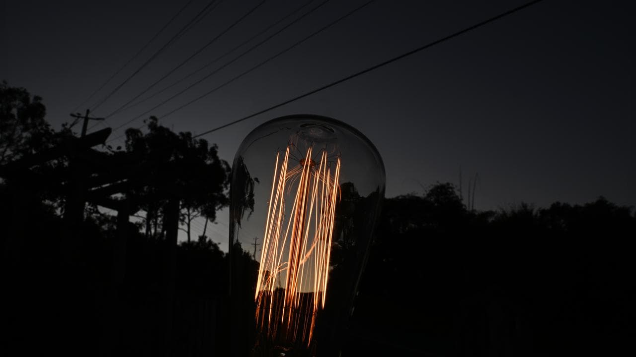 A generic image of a powered light bulb and powerlines.