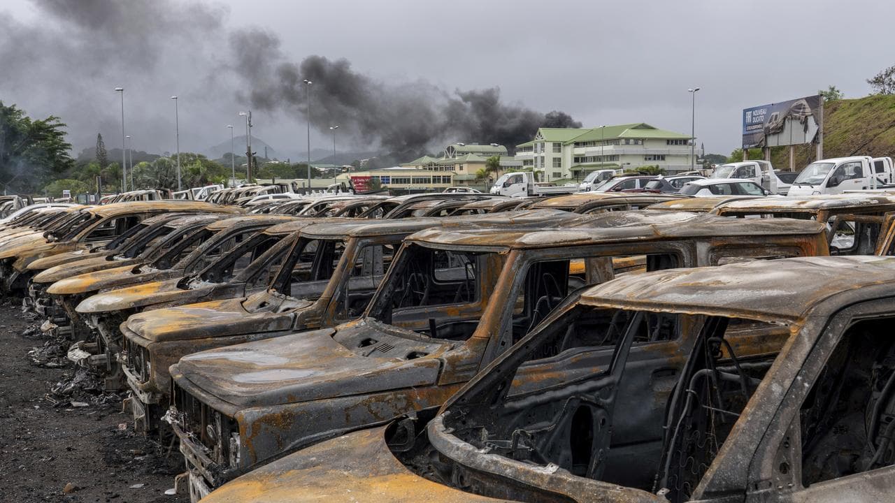 Burnt cars are lined up after unrest that erupted following protests