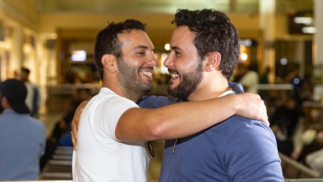 Traveller Fadi Chemali (left) arrives from New Caledonia