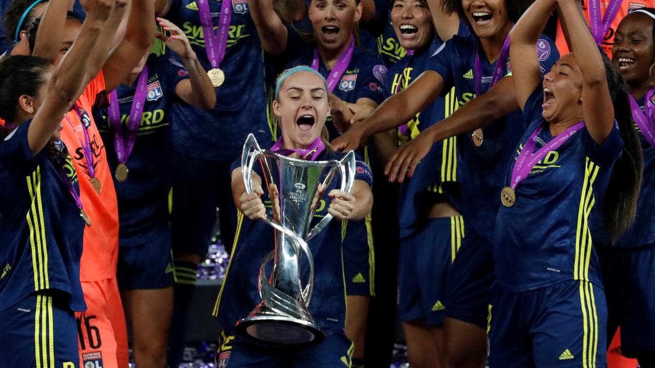 Ellie Carpenter lifts the 2020 Champions League trophy.