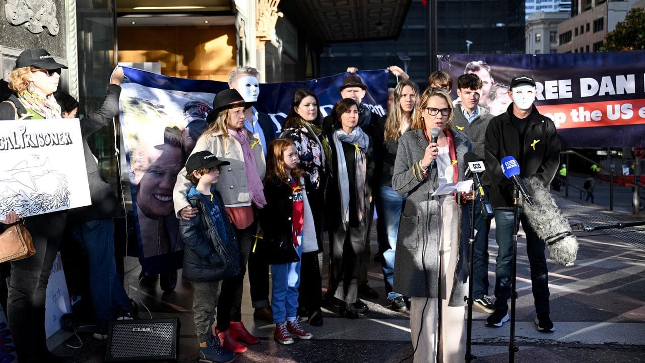 Saffrine Duggan (centre), wife of Daniel Duggan, speaks to media