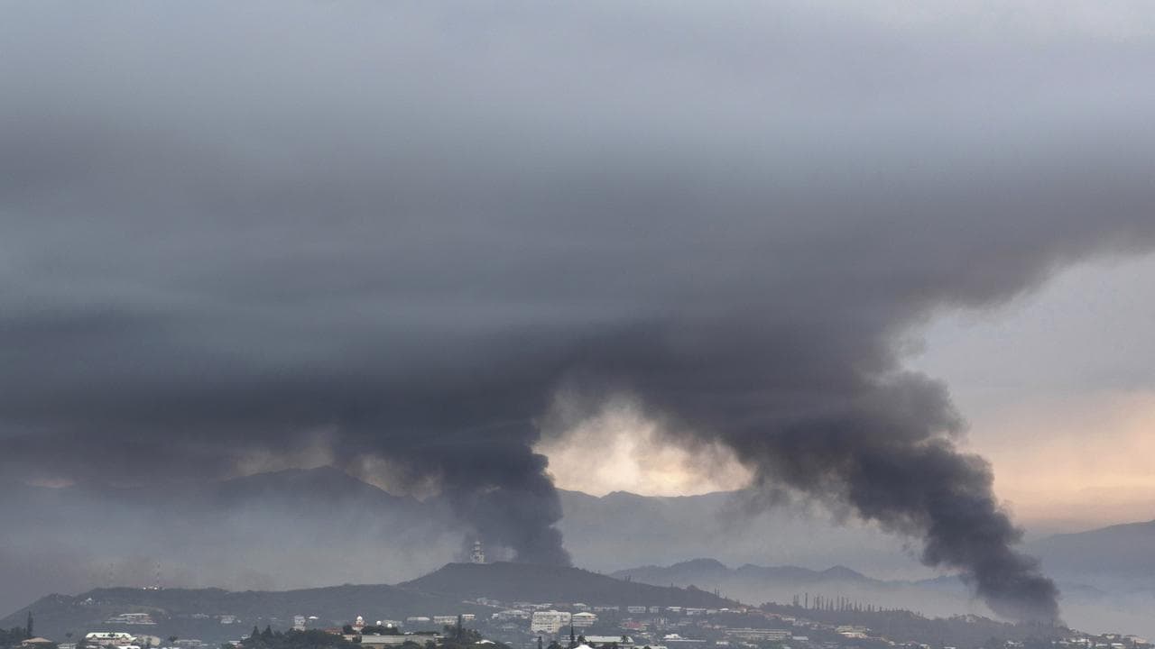 Smoke rises during protests in Noumea,