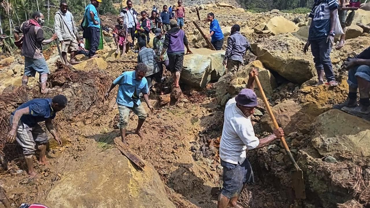 People digging in landslide rubble