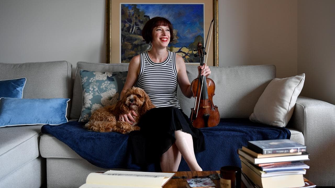 Madeleine Easton with her violin and dog.