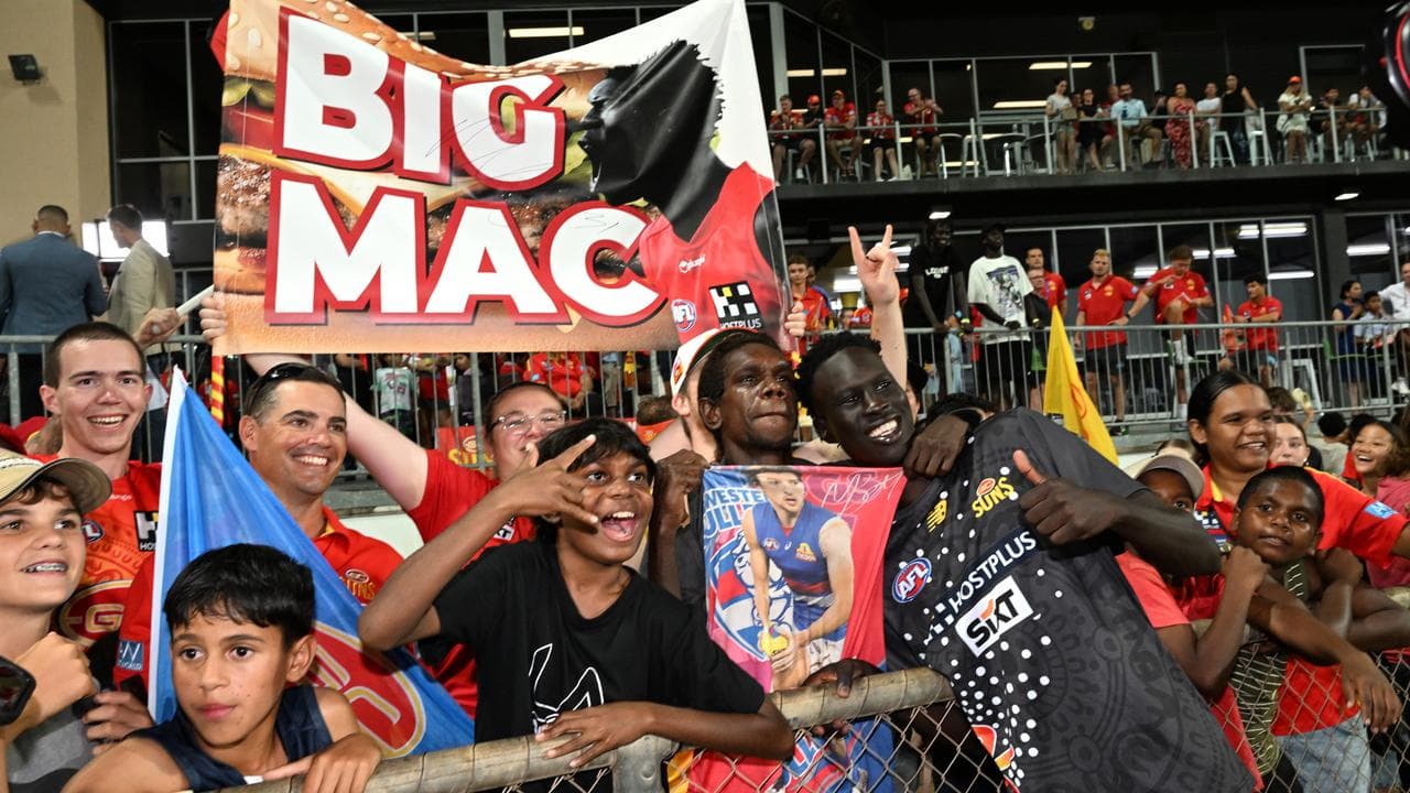 Mac Andrew of the Suns is seen with fans.