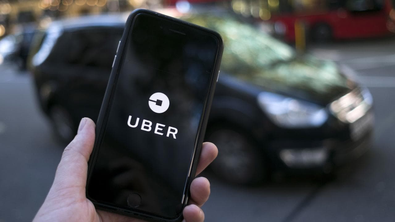 An Uber logo on a mobile telephone.